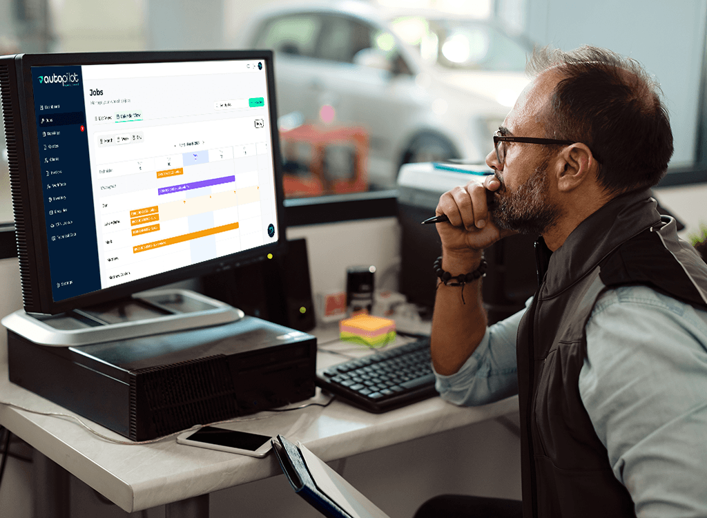Garage owner using Autopilot GMS dashboard to manage jobs, bookings and invoices